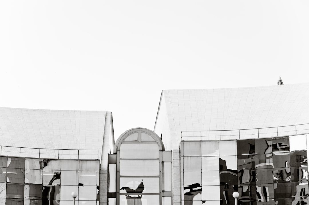 people-sitting-on-chairs-near-building-during-daytime-w3zucbigmka